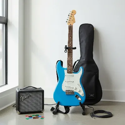 A Fender Player Stratocaster on a stand surrounded by essential guitar accessories like an amplifier, picks, capo, and tuner, in a studio setting. 