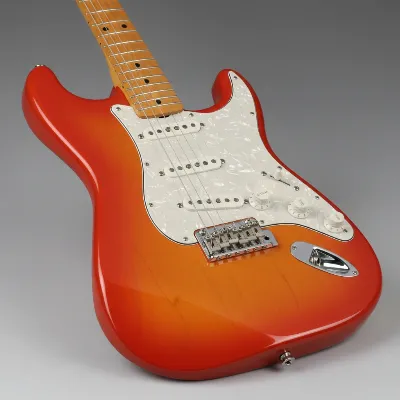 A detailed close-up of a Fender Player Stratocaster's alder body and maple neck joint, showcasing the gloss polyester finish and sleek contours.